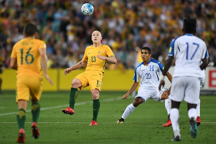 Socceroos' Aaron Mooy looks to control the ball against Honduras