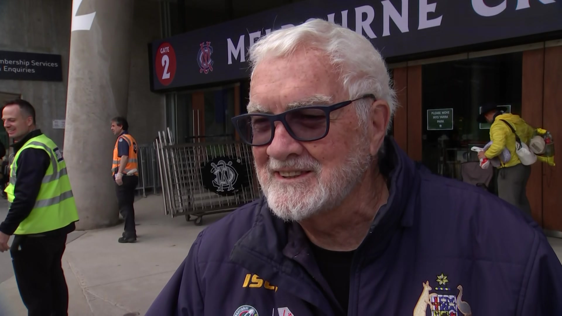 A man wearing glasses in front of the MCC entrance