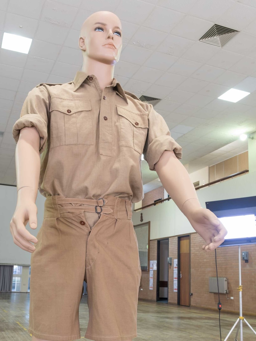 A mannequin wearing soldier's uniform and showing the fly partially open on the shorts.