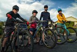 A family of four on their mountain bikes.