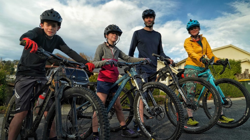 A family of four on their mountain bikes.