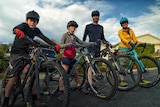 A family of four on their mountain bikes.