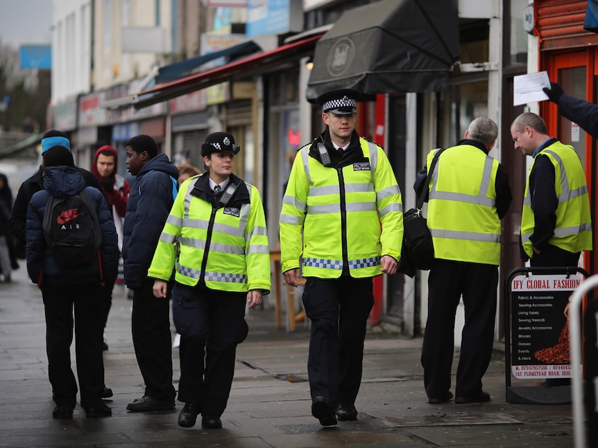 Police officers patrol Woolwich in London, England