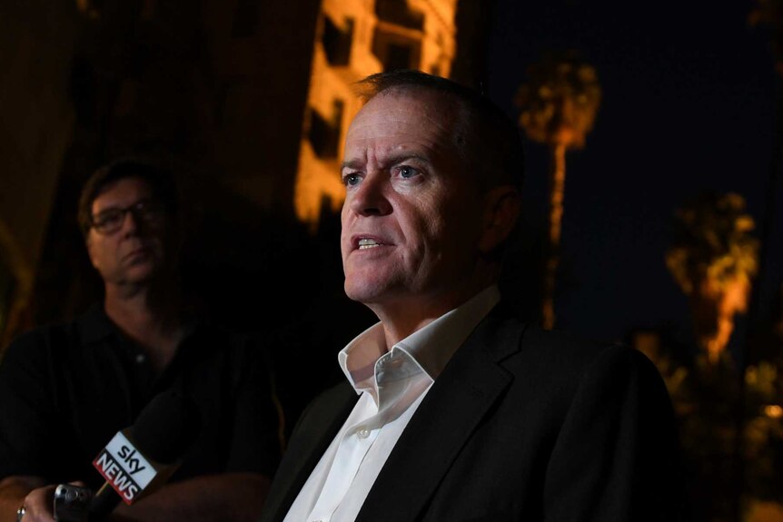 Opposition Leader Bill Shorten talks to media at night in Jerusalem.