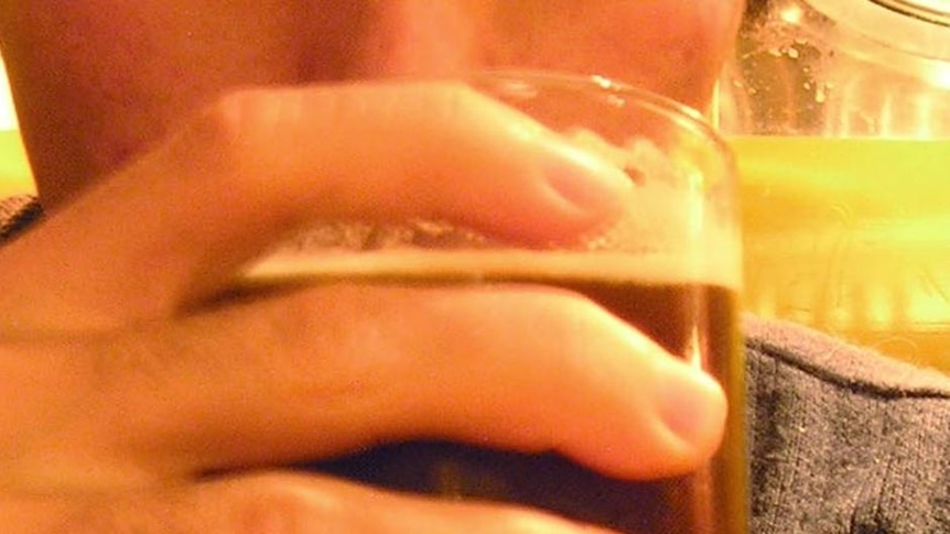 A man drinks a pint