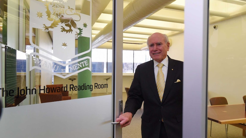 Former Prime Minister John Howard stands in the doorway of the reading room named in his honour.