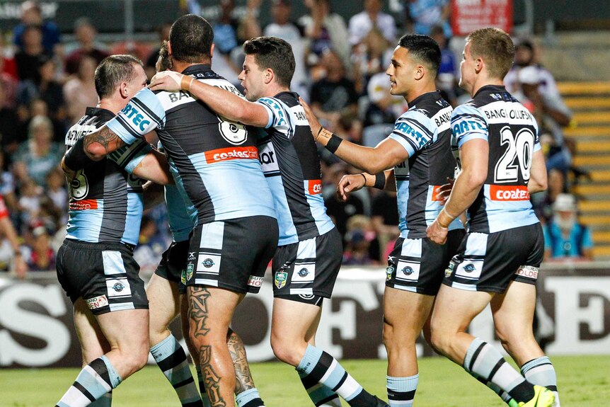 The Sharks congratulate Paul Gallen after he scores a try against the Cowboys.