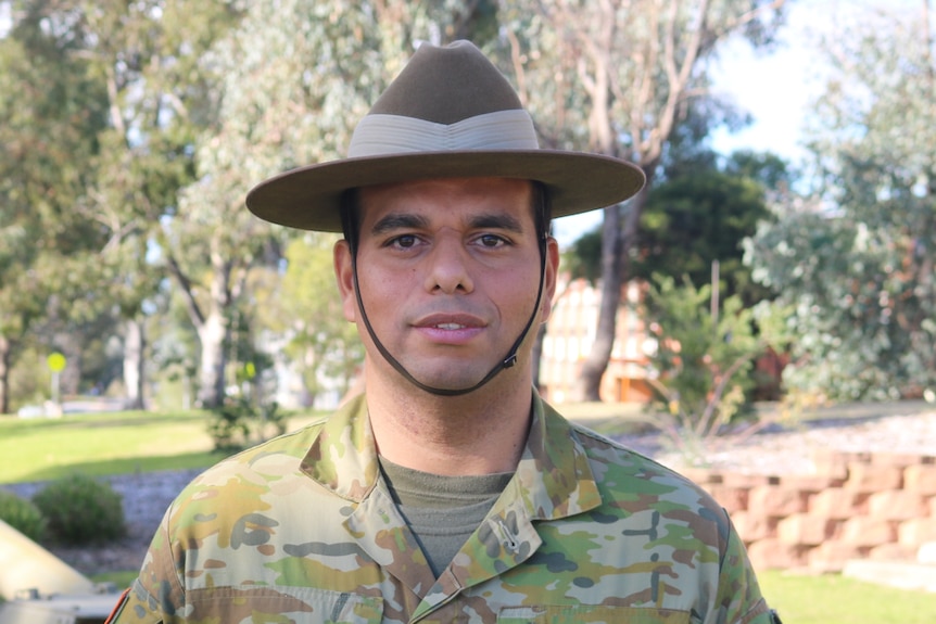 A man in army uniform and hat 