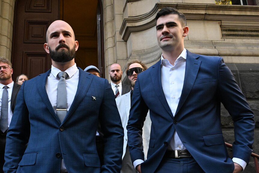  Thomas Sewell and Jacob Hersant standing next to each other on the steps outside the Victorian Court of Appeal. 