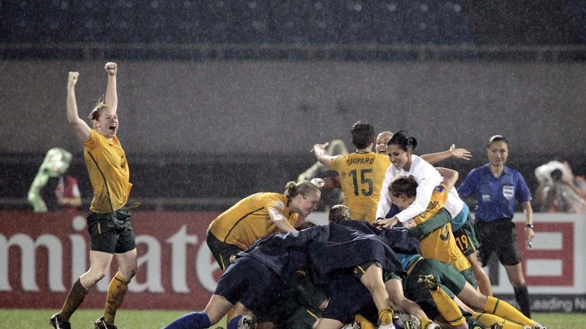 The Matildas celebrate after clinching their first Asian Cup triumph.