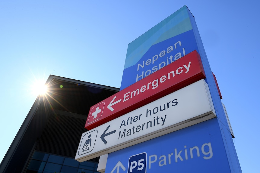 A hospital sign pointing the way to the emergency and maternity departments. 
