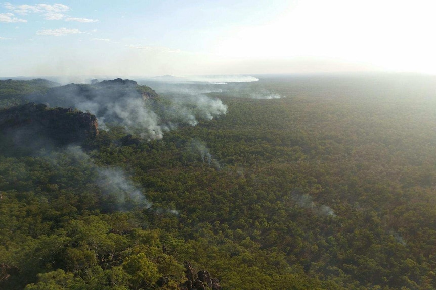 Smoke rises from a remote escarpment in Kakadu National Park, lit by incendiary devices dropped from helicopters.