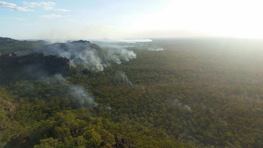 Smoke rises from a remote escarpment in Kakadu National Park, lit by incendiary devices dropped from helicopters