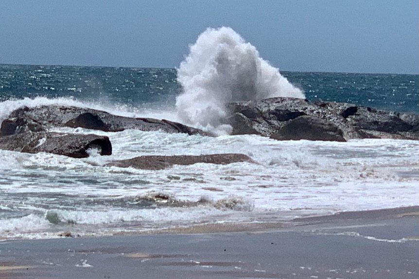 Large wave hitting rocks at the shore
