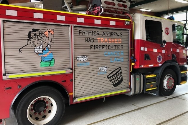 firetruck painted by union with slogan reading premier andrews has trashed firefighter cancer laws 
