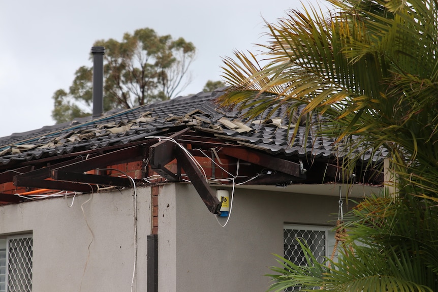 Tiles have been ripped off a roof in a suburban area