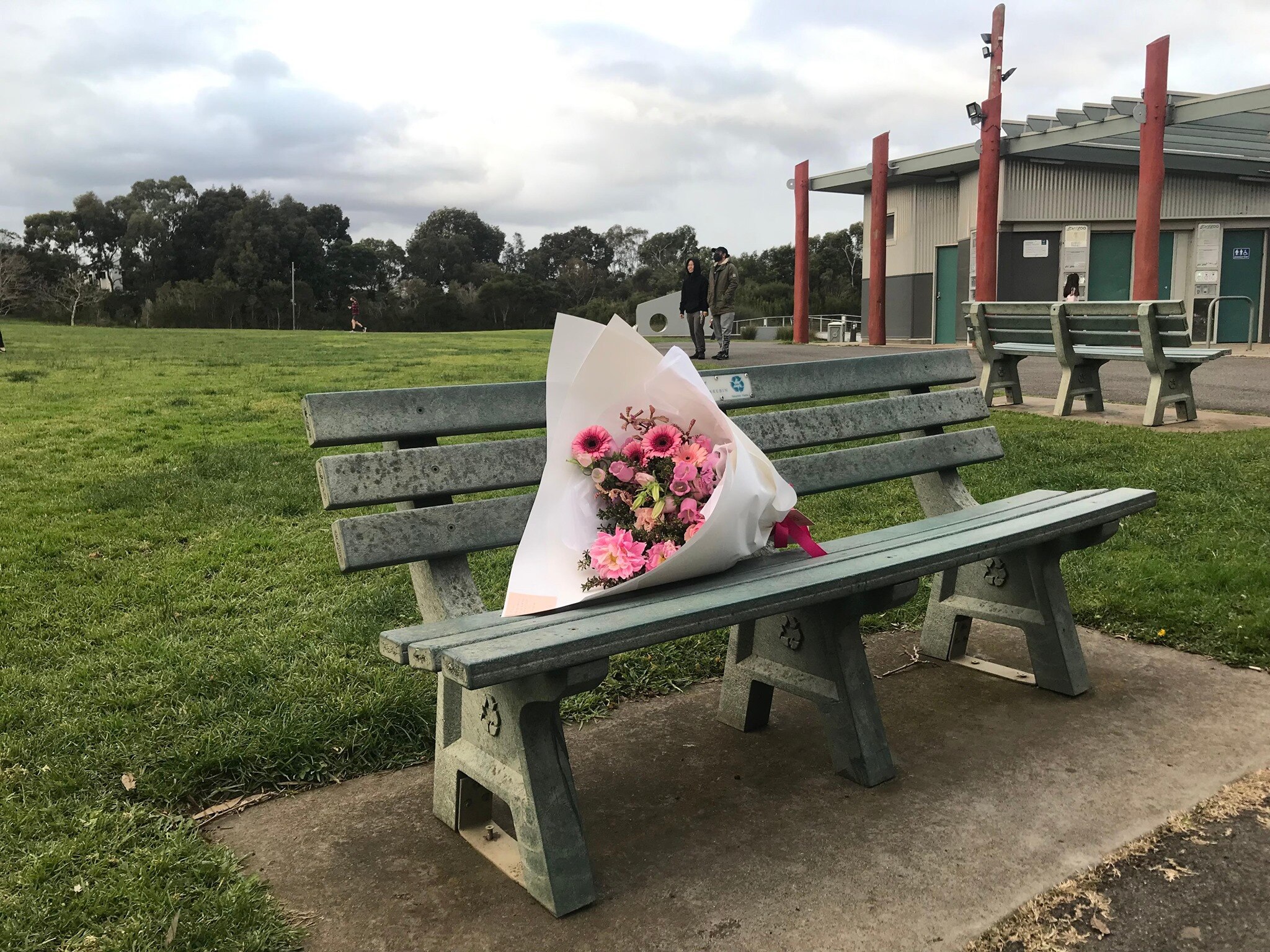 A flower bouquet on a park bench in Northcote.