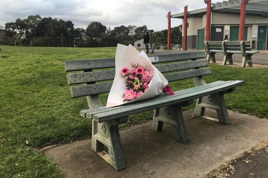 A flower bouquet on a park bench in Northcote.