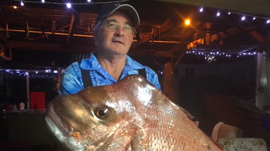 Man holding a very large fish.