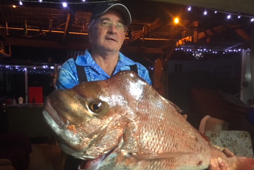 Man holding a very large fish.