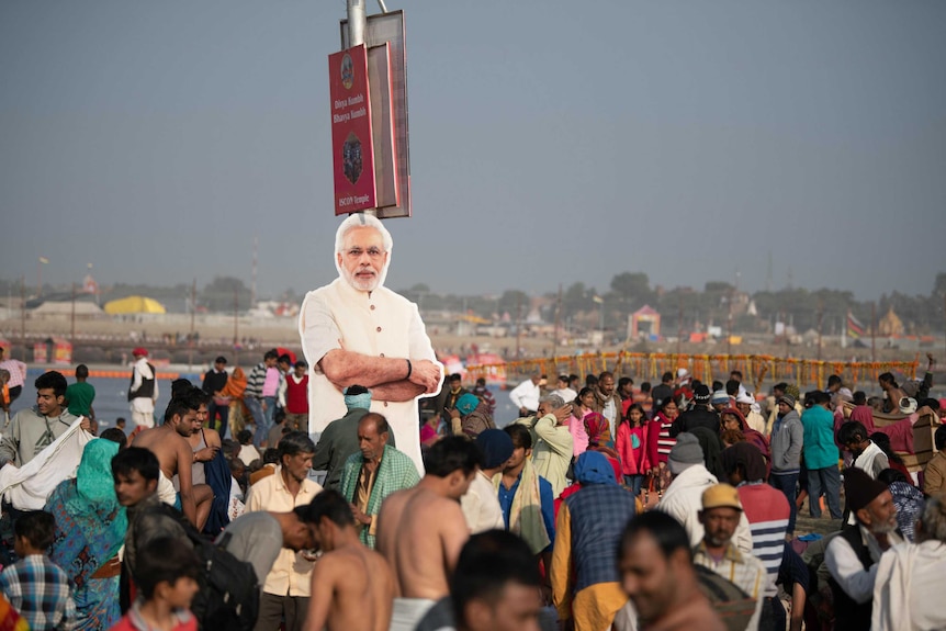 A poster of Indian PM Narendra Modi among the crowd attending Kumbh Mela