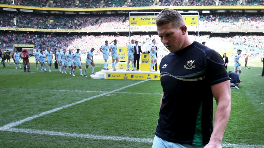 Northampton's Dylan Hartley walks off with his runner-up medal after the English Premiership final.