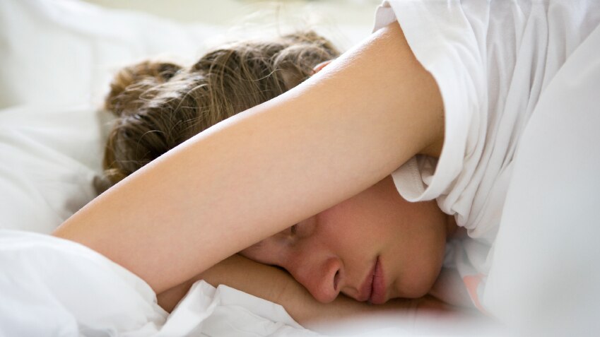 Women sleeping with arm over her head