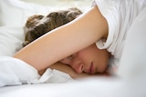Women sleeping with arm over her head