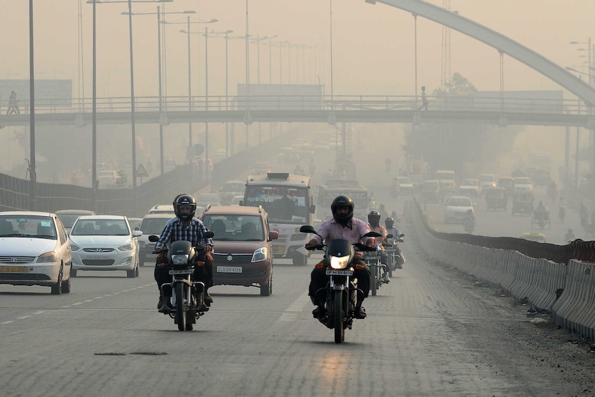 Indian motorists drive on a major road