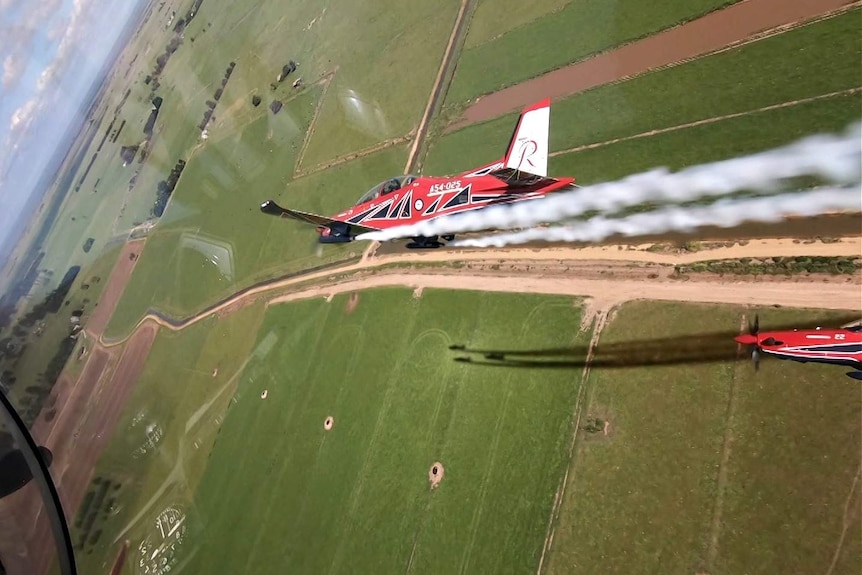 A view out the cockpit of another Roulette blasting smoke.