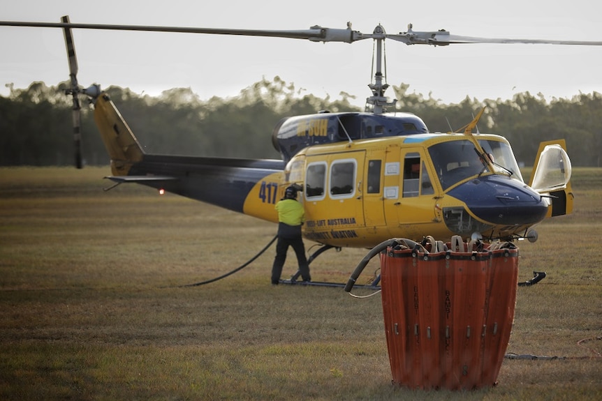 Water bombing helicopter refuels.