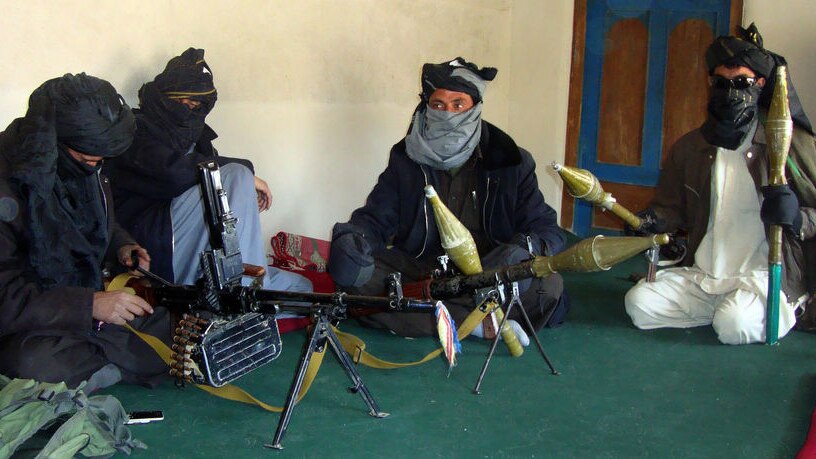 Taliban fighters display their weapons