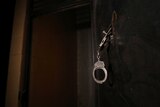 Handcuffs hang on a prison door