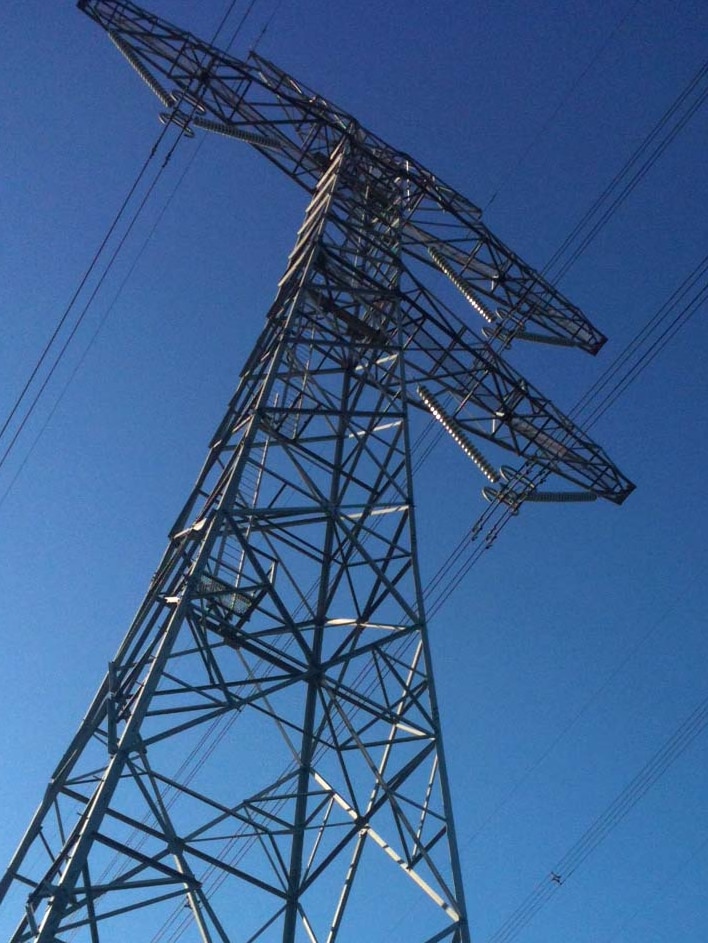 Electricity tower against blue sky