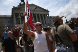 White supremacists from the White Knights of the Ku Klux Klan protest over the Confederate flag's removal from the state building
