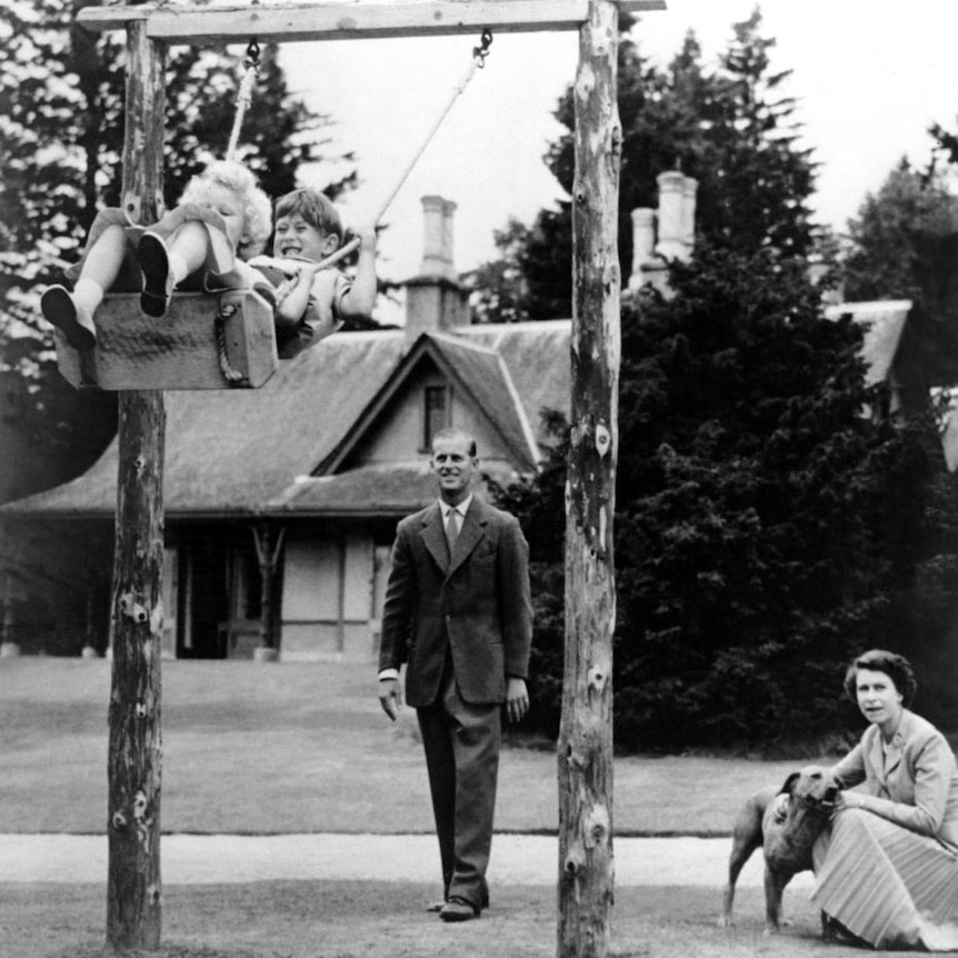 Queen Elizabeth II and Prince Philip and their two children, Charles and Anne, play at Balmoral.