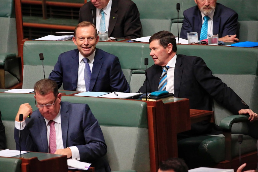 Former prime minster Tony Abbott and backbencher Kevin Andrews sit together in Parliament.