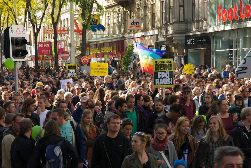 Protesters walk down Vienna street