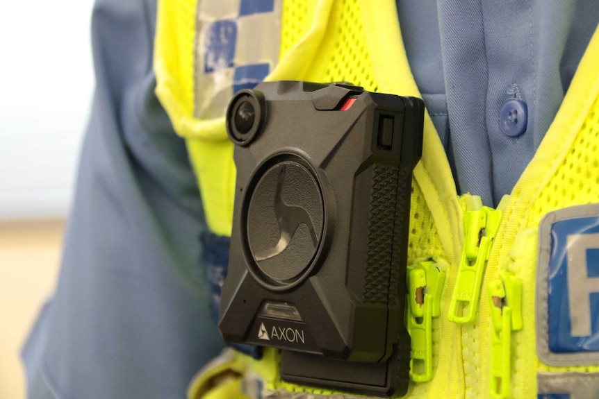 A black compact camera worn by a policeman