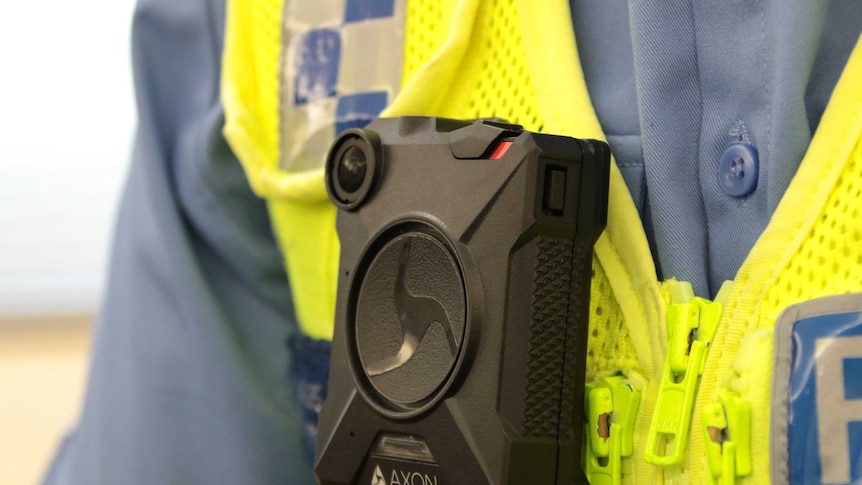 A black compact camera worn by a policeman