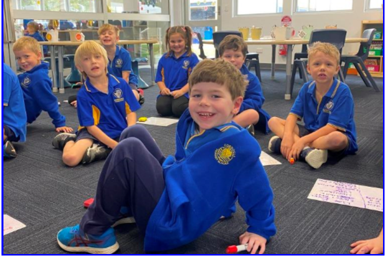 Group of primary school students sitting together in a classroom 