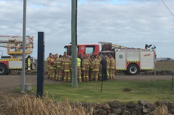 Firefighters being briefed outside the Metropolitan Remand Centre at Ravenhall.