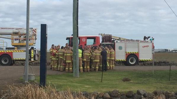 Firefighters being briefed outside the Metropolitan Remand Centre at Ravenhall.
