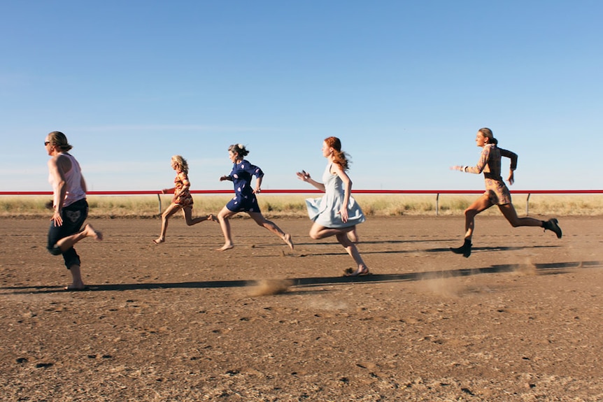 Five women running on the dusty Maxwelton race track.