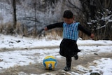 Afghan Lionel Messi fan Murtaza Ahmadi, 5, wears a plastic bag jersy as he plays football