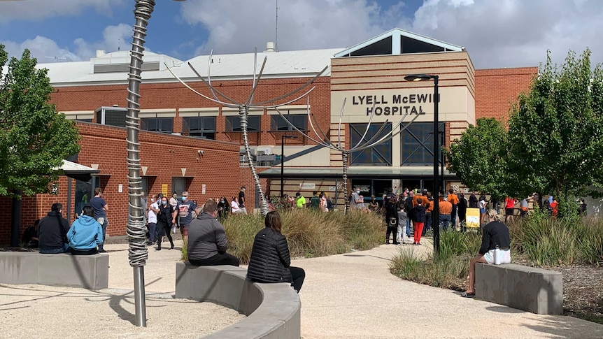 People lining up outside a hospital