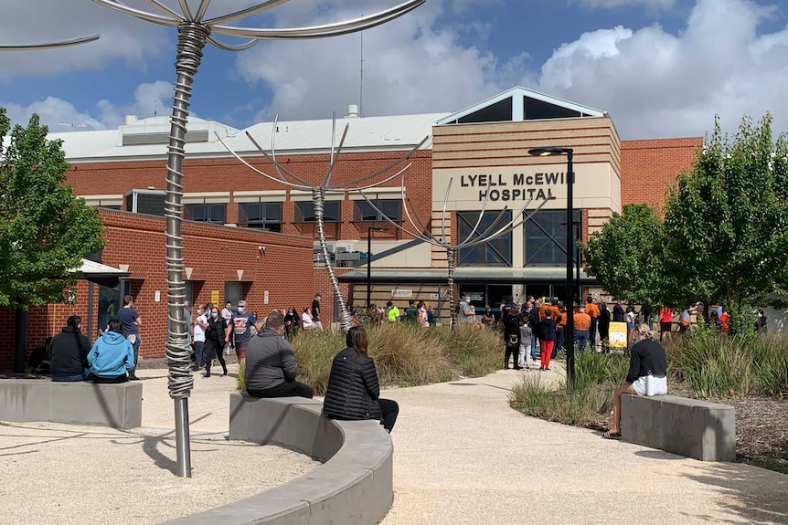 People lining up outside a hospital