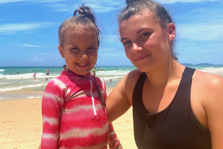 young child and mother on beach