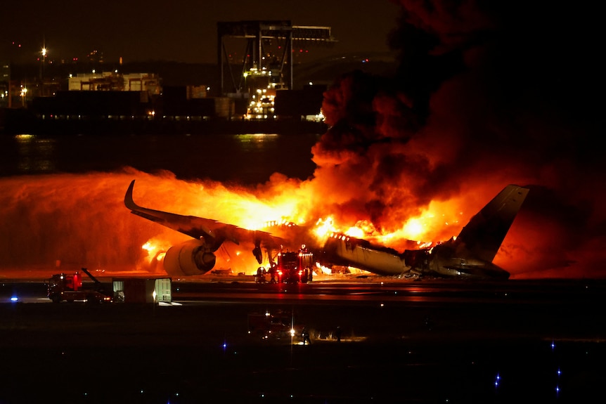 Plane engulfed in flames at nightfall 