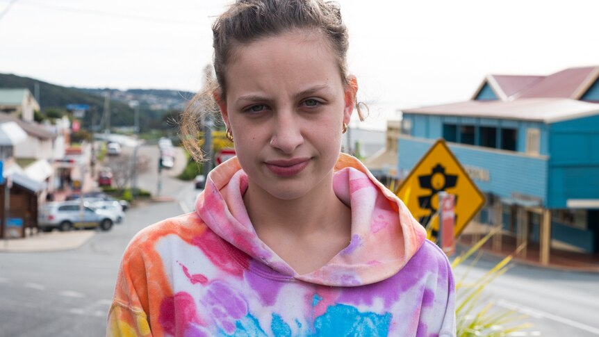Teenage girl standing in the middle of the street in Narooma